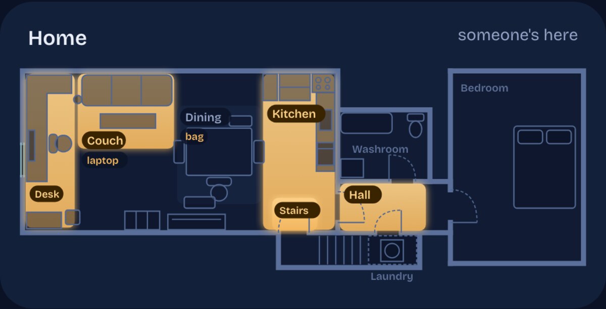 A dark floorplan of the apartment. The desk, couch, kitchen, stairs and hallway areas glow amber; the washroom, laundry and bedroom are outlined